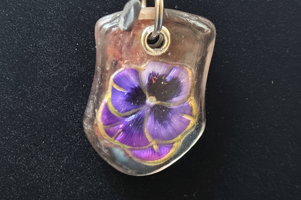 Purple flower pendant on a black background
