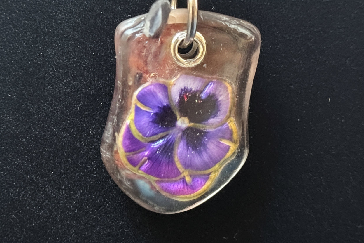 Purple flower pendant on a black background